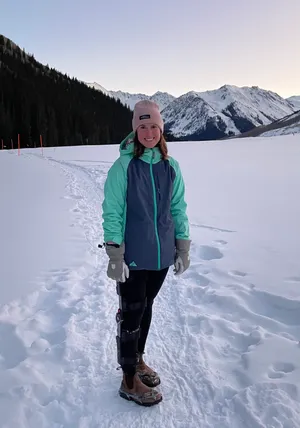 Teika, wearing her leg brace, on her first walk with Sam in the snow